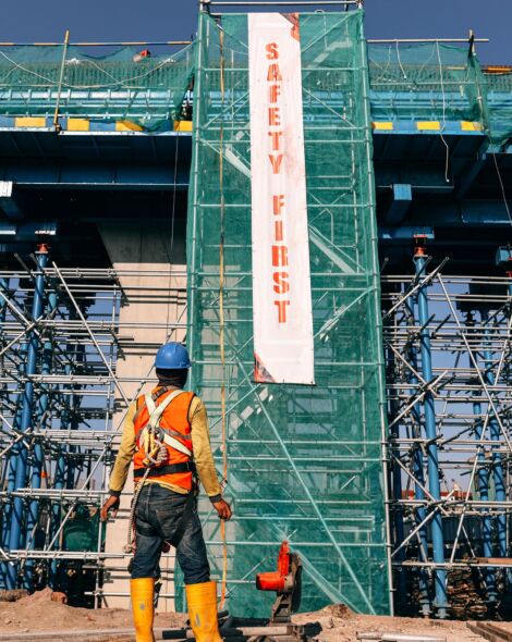 worker-at-construction-site-with-safety-first-bann-2021-09-04-09-41-39-utc